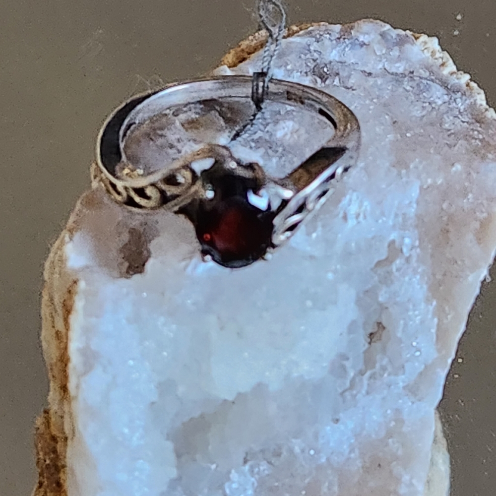 Women's 925 Garnet Ring with cutout detail on sides.